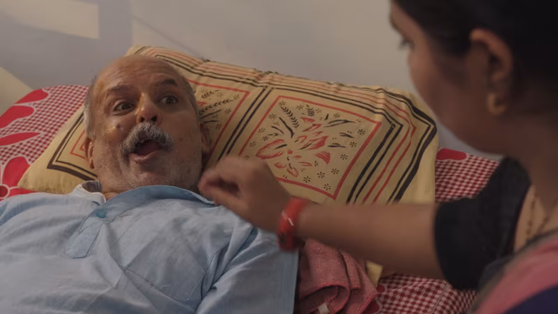 His daughter-in-law leans in to feed him