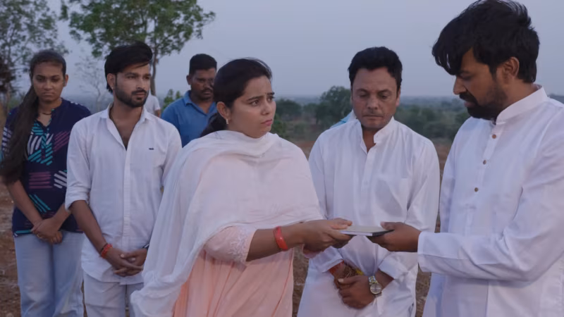 The village stands in the field while the papers are read out