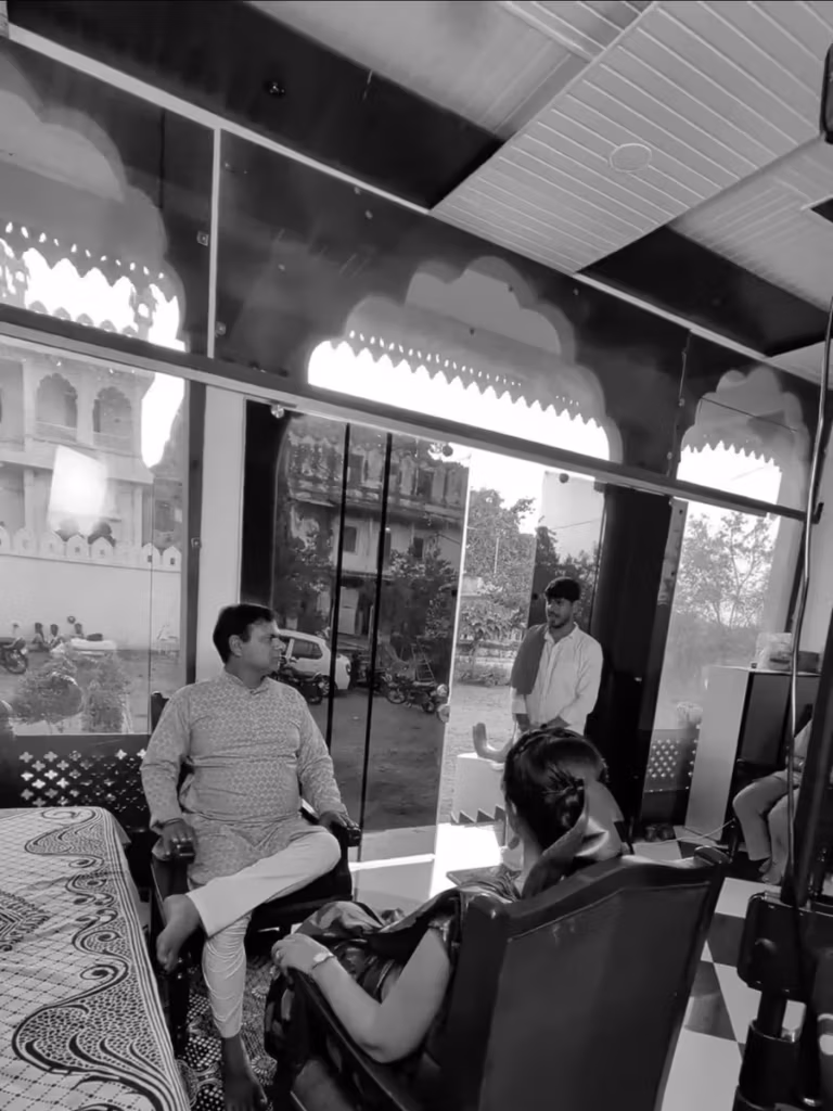 Actors and crew in the mirrored doorway of the shop set