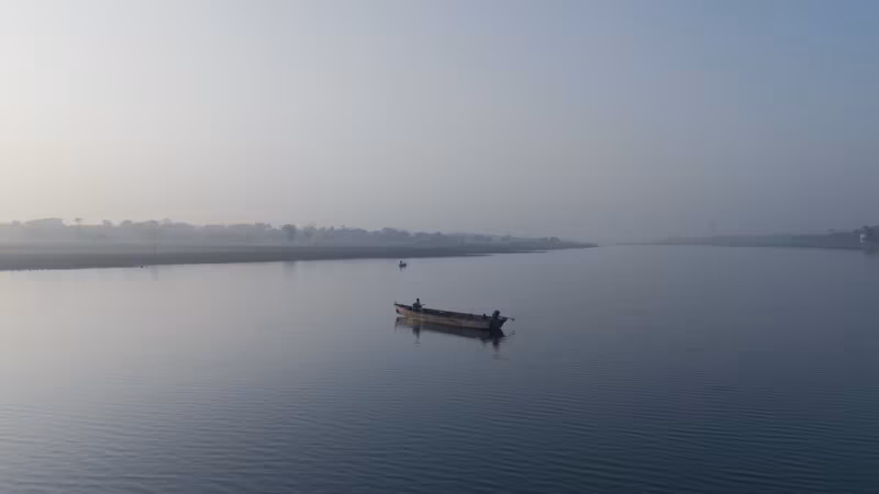 A still from Mere Dil Mein Bhole Baba: a single boat on still water at dawn